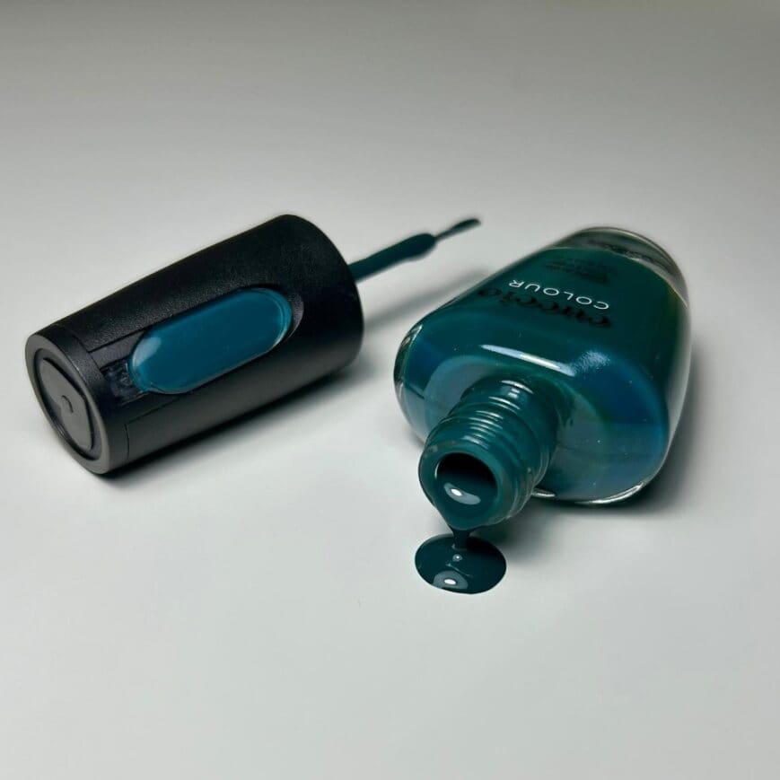 tickled-turquoise-lacquer-bottle-pouring-onto-table.jpg